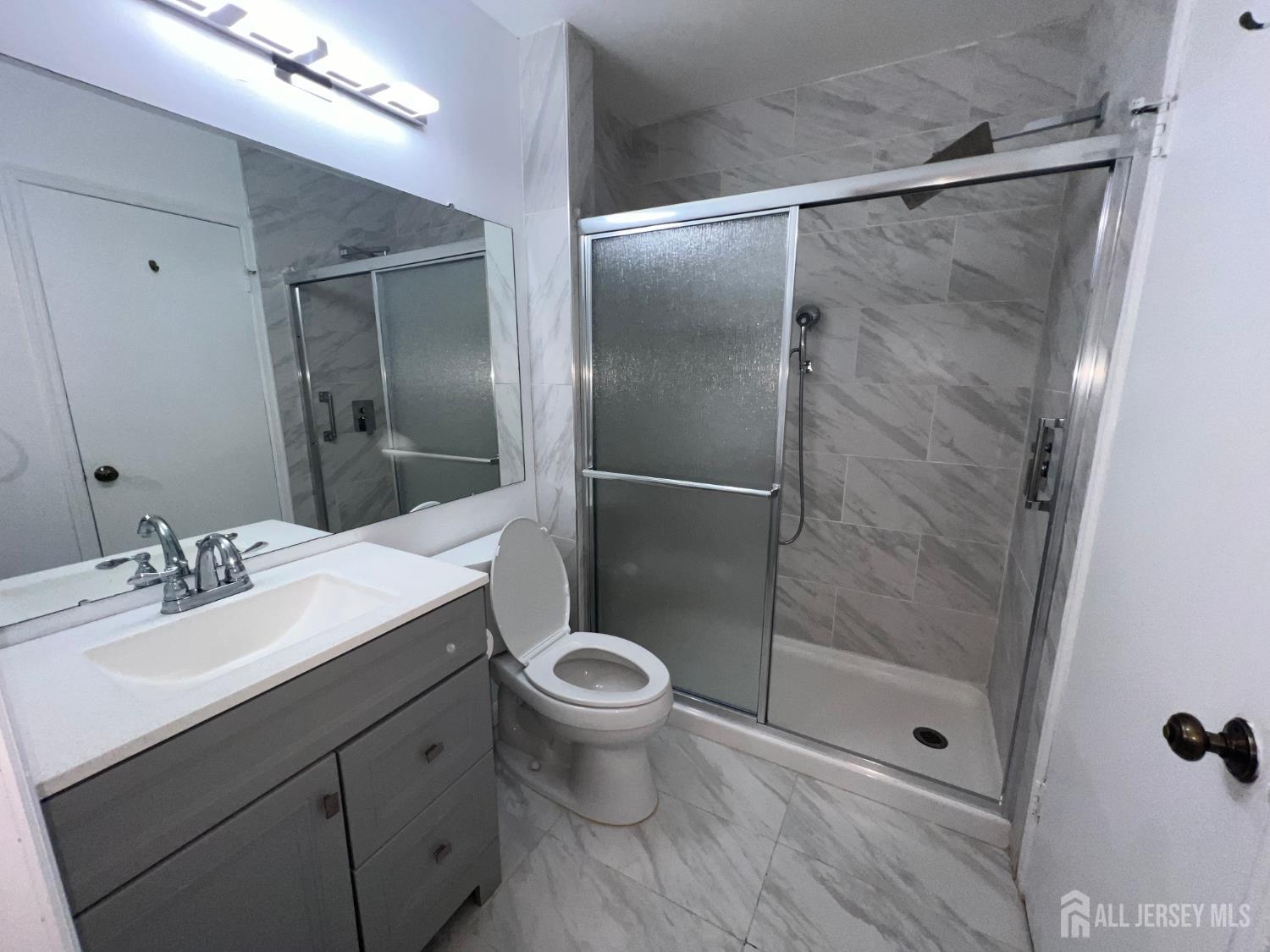 68 Delancy Court North Brunswick, NJ 08902 - Photo 7 of 17 a bathroom with a shower sink vanity and toilet
