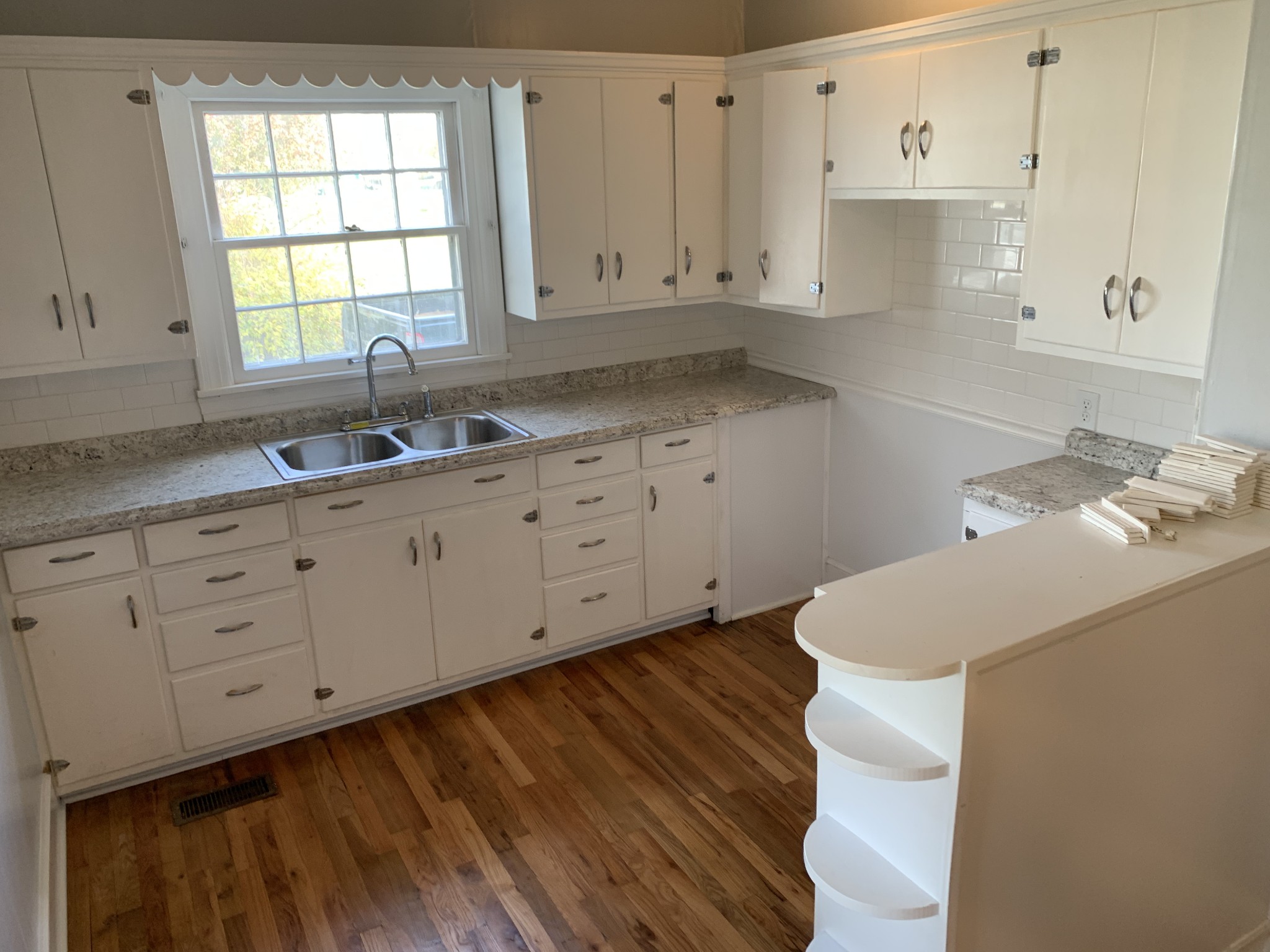 320 Franklin Road Lebanon, TN 37087 - Photo 10 of 19 a kitchen with granite countertop white cabinets white appliances and a wide window