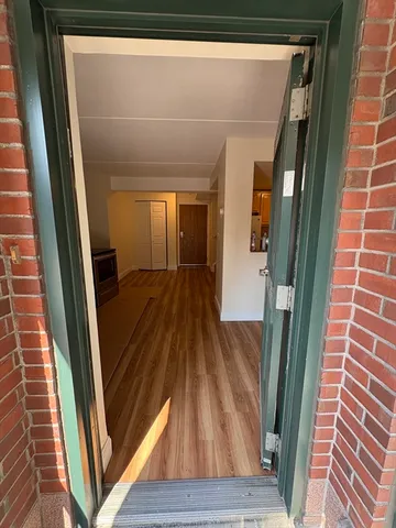 a view of a hallway and wooden floor