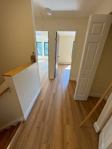 a view of a hallway and wooden floor