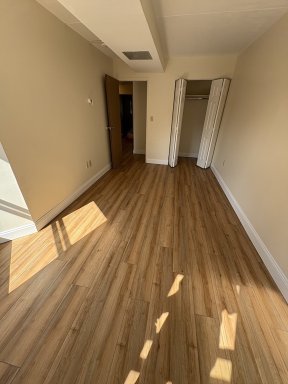 400 Massachusetts Avenue, Unit 34 Boston, MA 02115 - Photo 15 of 24 a view of a hallway with wooden floor