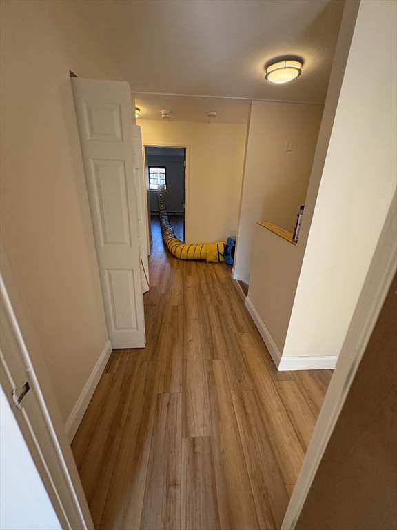 400 Massachusetts Avenue, Unit 34 Boston, MA 02115 - Photo 17 of 24 a view of a room with wooden floor