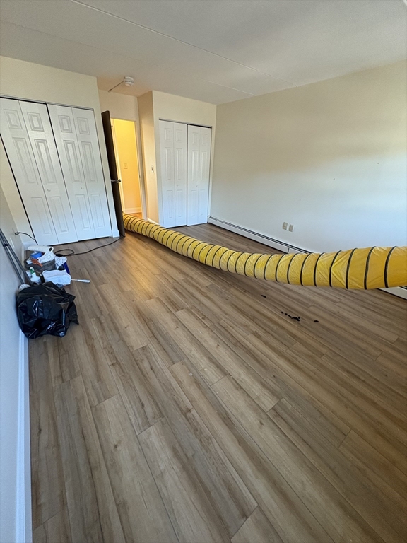 400 Massachusetts Avenue, Unit 34 Boston, MA 02115 - Photo 18 of 24 a view of a room with wooden floor
