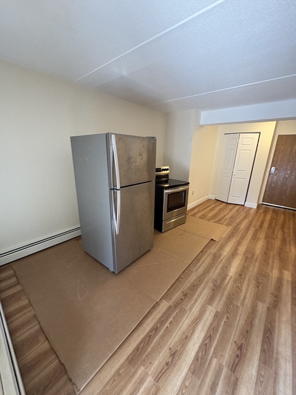 400 Massachusetts Avenue, Unit 34 Boston, MA 02115 - Photo 2 of 24 a view of kitchen with refrigerator and cabinet