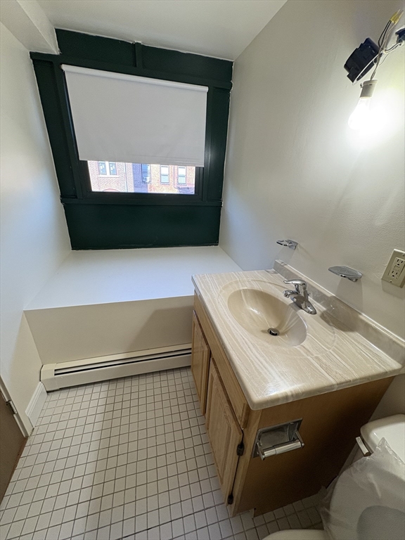 400 Massachusetts Avenue, Unit 34 Boston, MA 02115 - Photo 21 of 24 a bathroom with a sink and a mirror