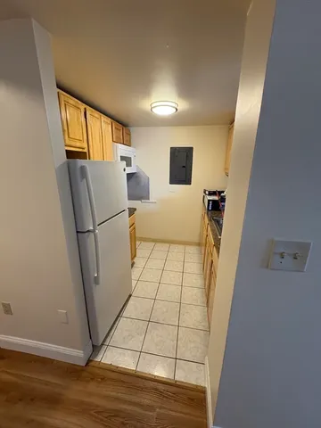 a view of a hallway with furniture and wooden floor