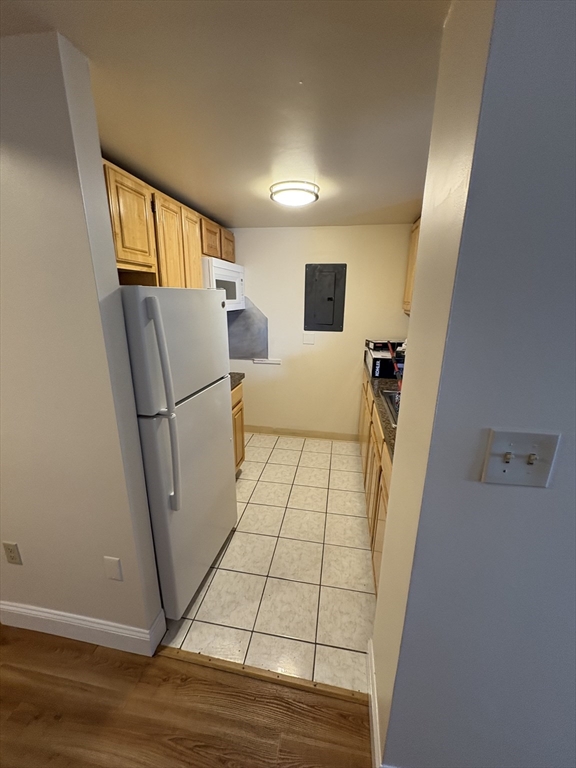 400 Massachusetts Avenue, Unit 34 Boston, MA 02115 - Photo 5 of 24 a view of a hallway with furniture and wooden floor