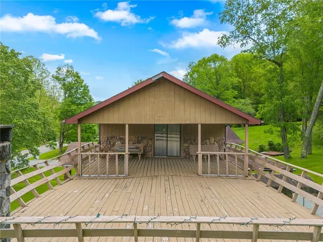a view of a balcony with wooden floor and outdoor seating