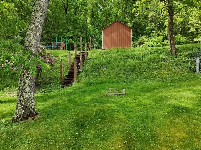 an aerial view of a house with a yard