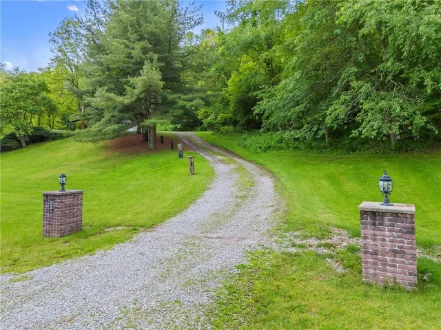 a front view of a house with a yard table and chairs