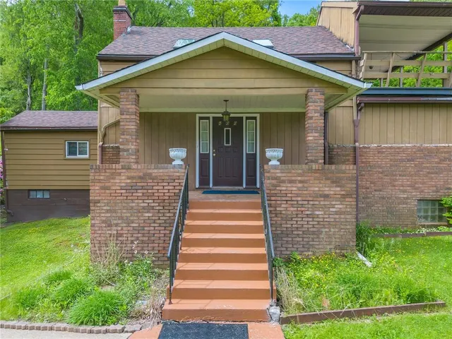 a front view of a house with a garden