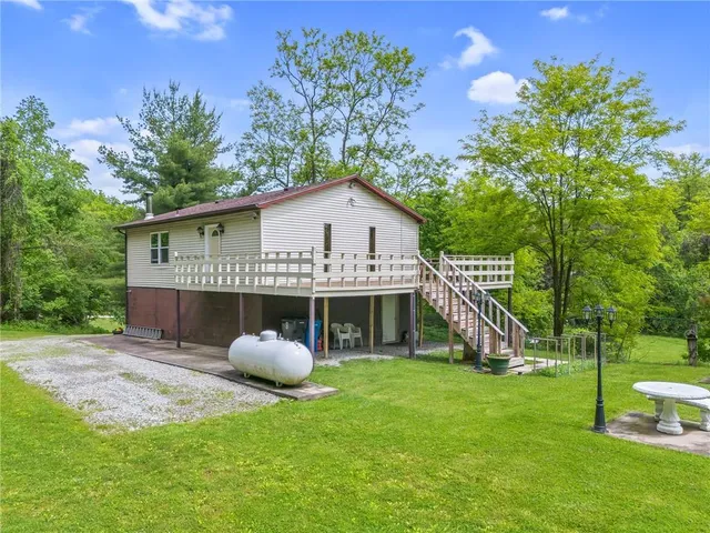 a backyard of a house with a yard and outdoor seating