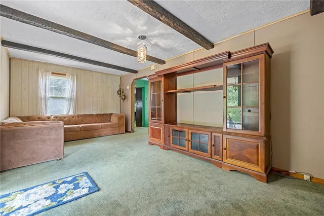 a kitchen with stainless steel appliances granite countertop a refrigerator a stove a sink dishwasher and a refrigerator with wooden floor