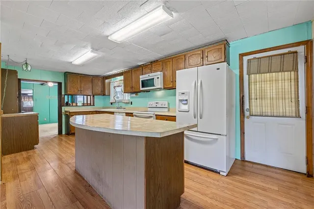 a kitchen with granite countertop a sink cabinets and stainless steel appliances