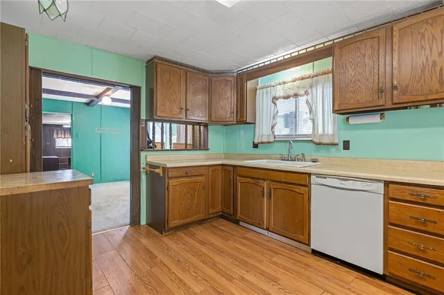a kitchen with a stove a sink and a refrigerator
