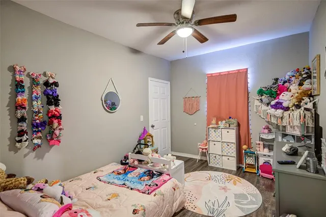 a bedroom with a bed a couch and dresser