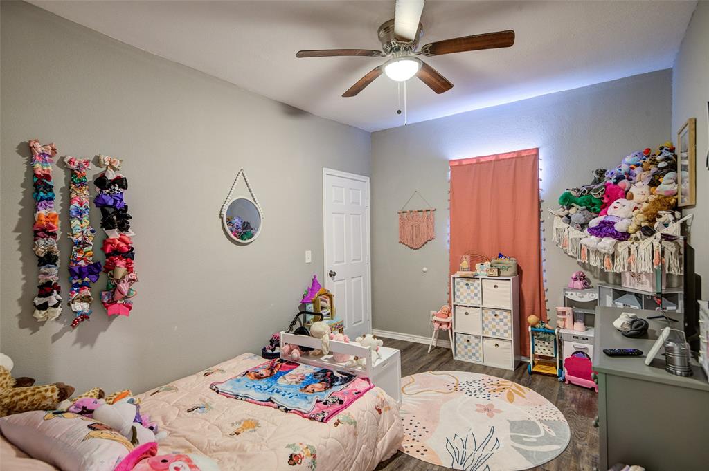 308 Cooke Street Nocona, TX 76255 - Photo 16 of 22 a bedroom with a bed a couch and dresser