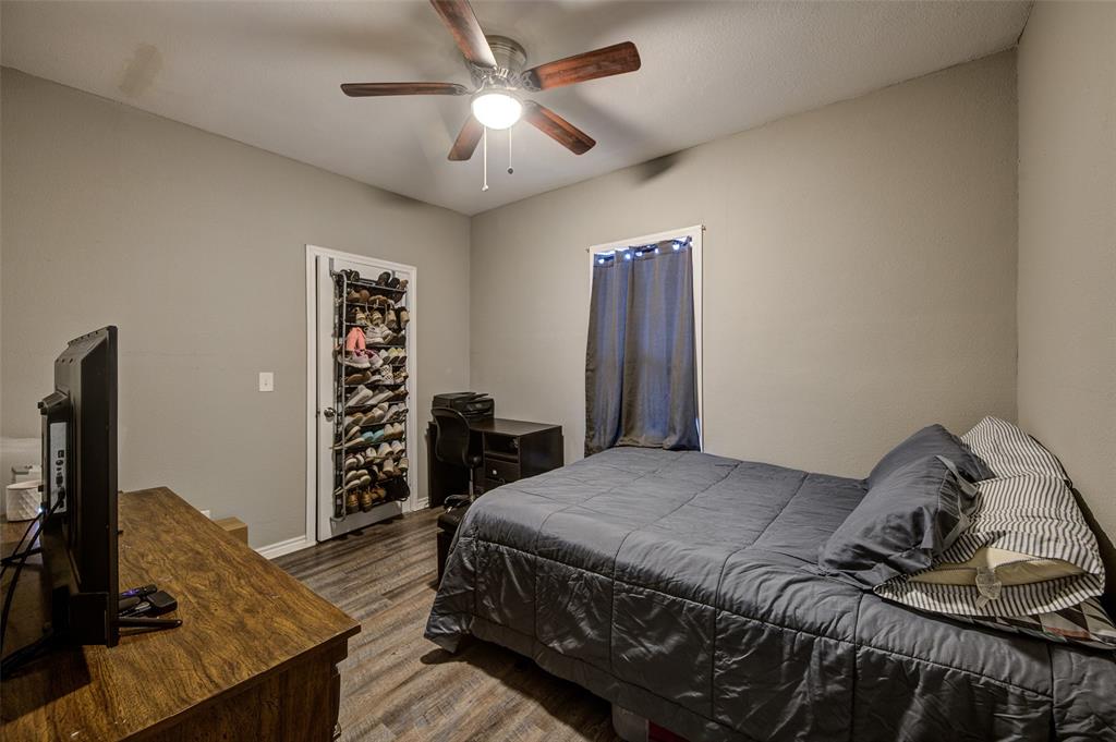 308 Cooke Street Nocona, TX 76255 - Photo 17 of 22 a bedroom with a bed and a flat screen tv