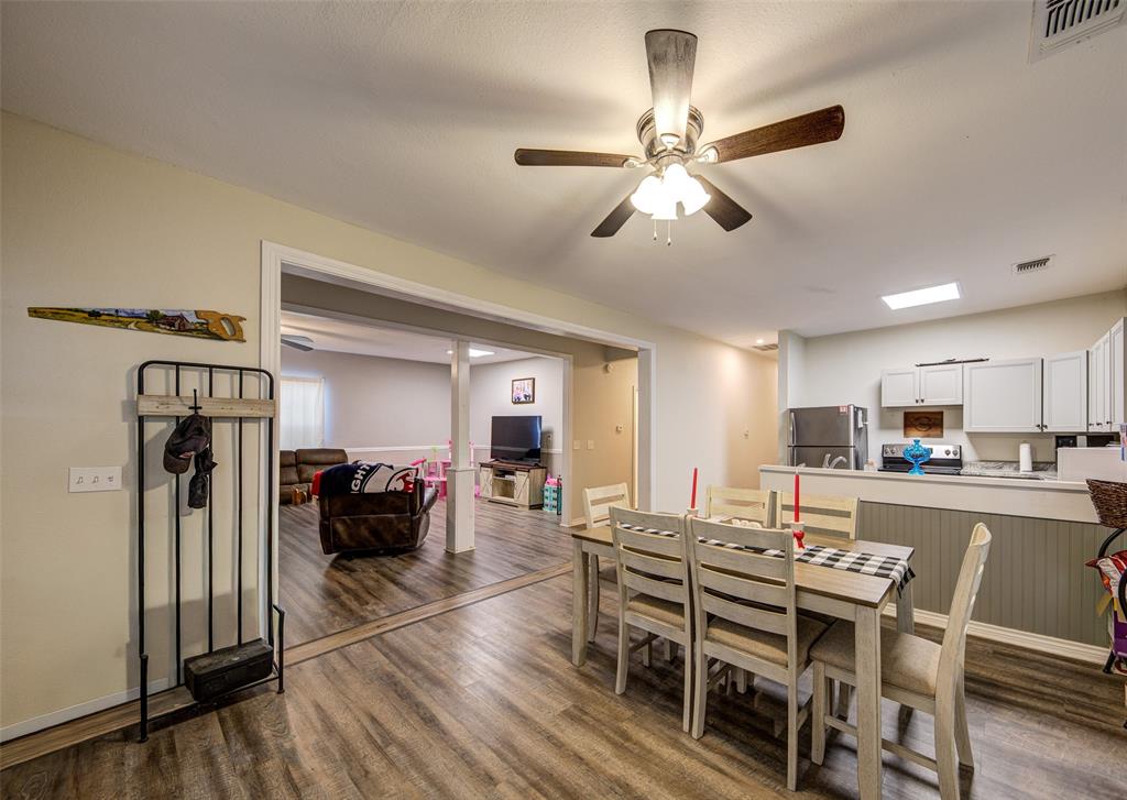 308 Cooke Street Nocona, TX 76255 - Photo 3 of 22 a view of a dining room with furniture and wooden floor