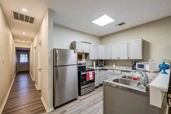 a kitchen with a refrigerator a sink and dishwasher