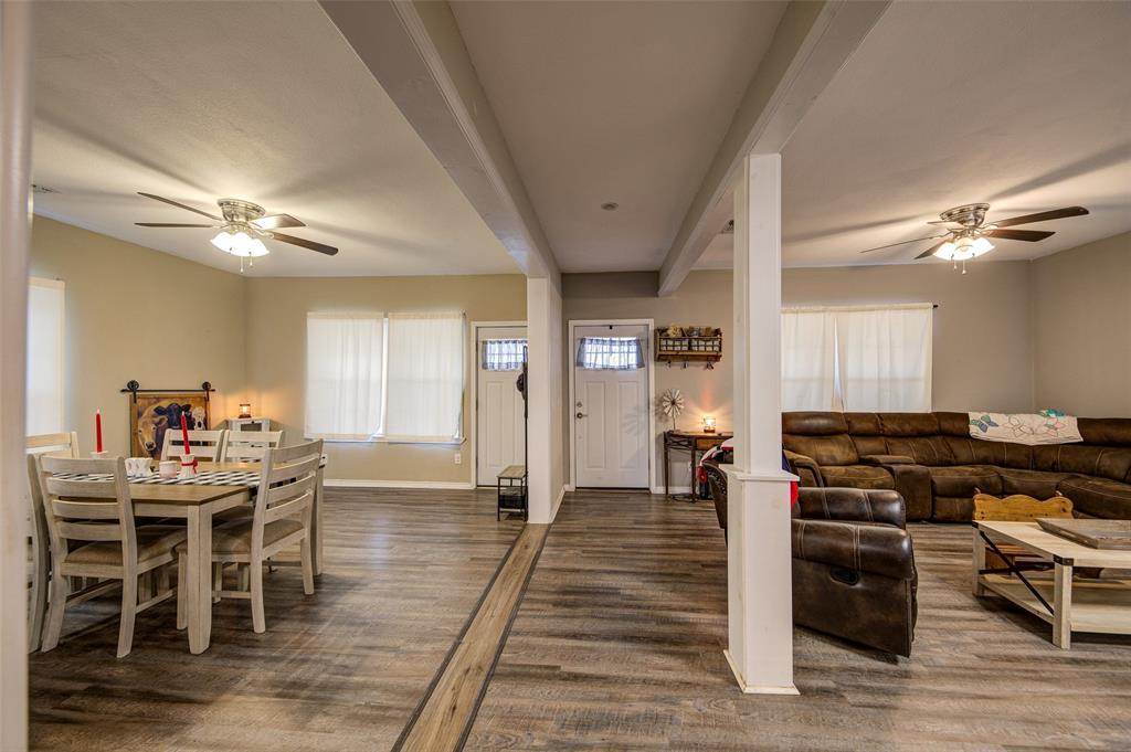 308 Cooke Street Nocona, TX 76255 - Photo 8 of 22 a kitchen with stainless steel appliances a stove a table and chairs