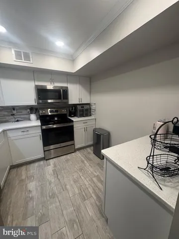 a kitchen with a sink a stove and cabinets