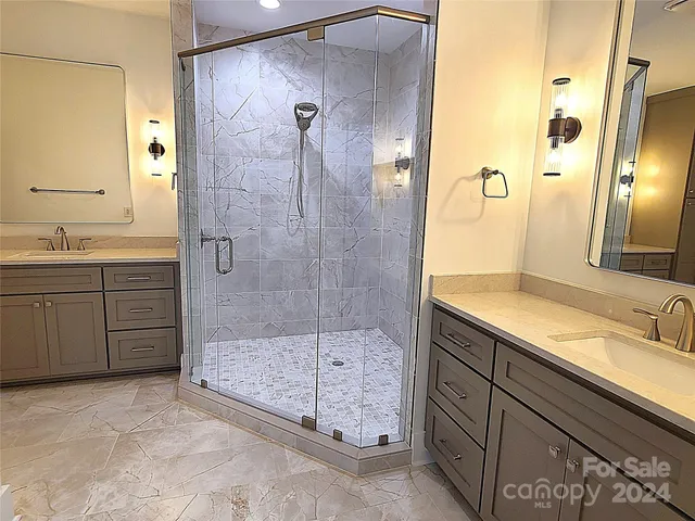 a bathroom with a shower sink and mirror
