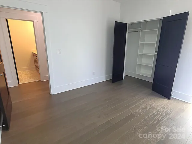 an empty room with a wooden door and door