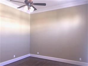 1824 Wichita Street, Unit B Houston, TX 77004 - Photo 13 of 18 an empty room with a chandelier fan and wooden floor