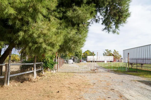 a view of a backyard with wooden fence