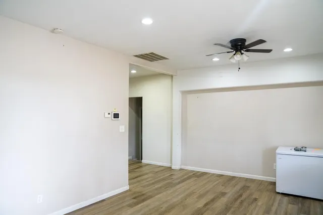 a view of a room with a sink and cabinets
