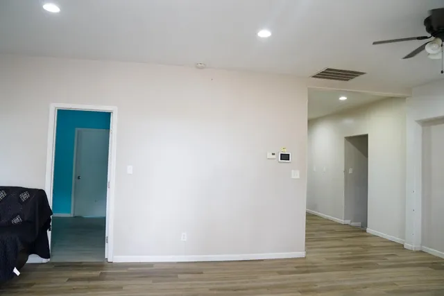 a view of a hallway with wooden floor