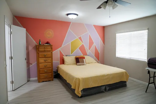 a bedroom with a bed and a couch