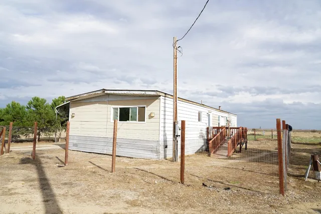 a view of wooden bench in a backyard