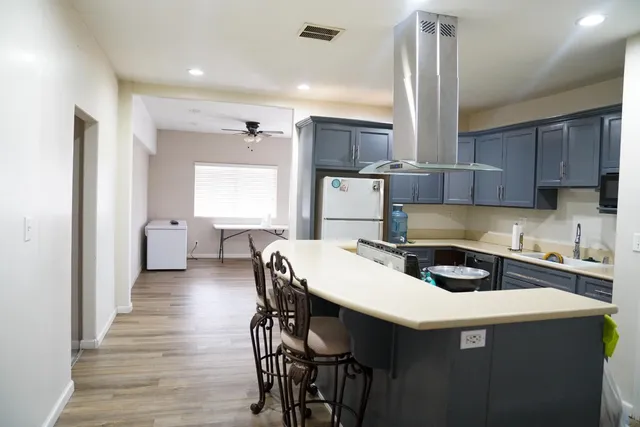 a kitchen that has a table and chairs in it