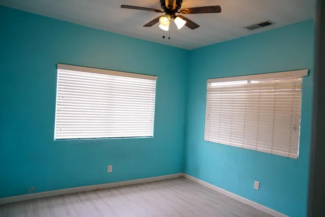 a view of a room with a window and a ceiling fan