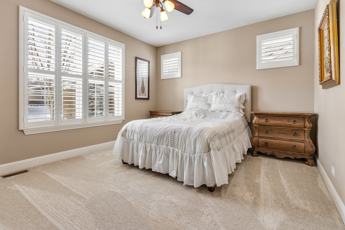 1093 Glendale Road Pingree Grove, IL 60140 - Photo 11 of 28 a bedroom with a bed next to a window and a chandelier