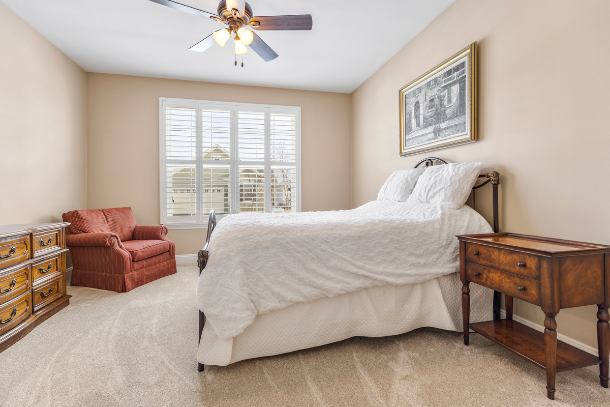 1093 Glendale Road Pingree Grove, IL 60140 - Photo 14 of 28 a bedroom with a bed and a chandelier