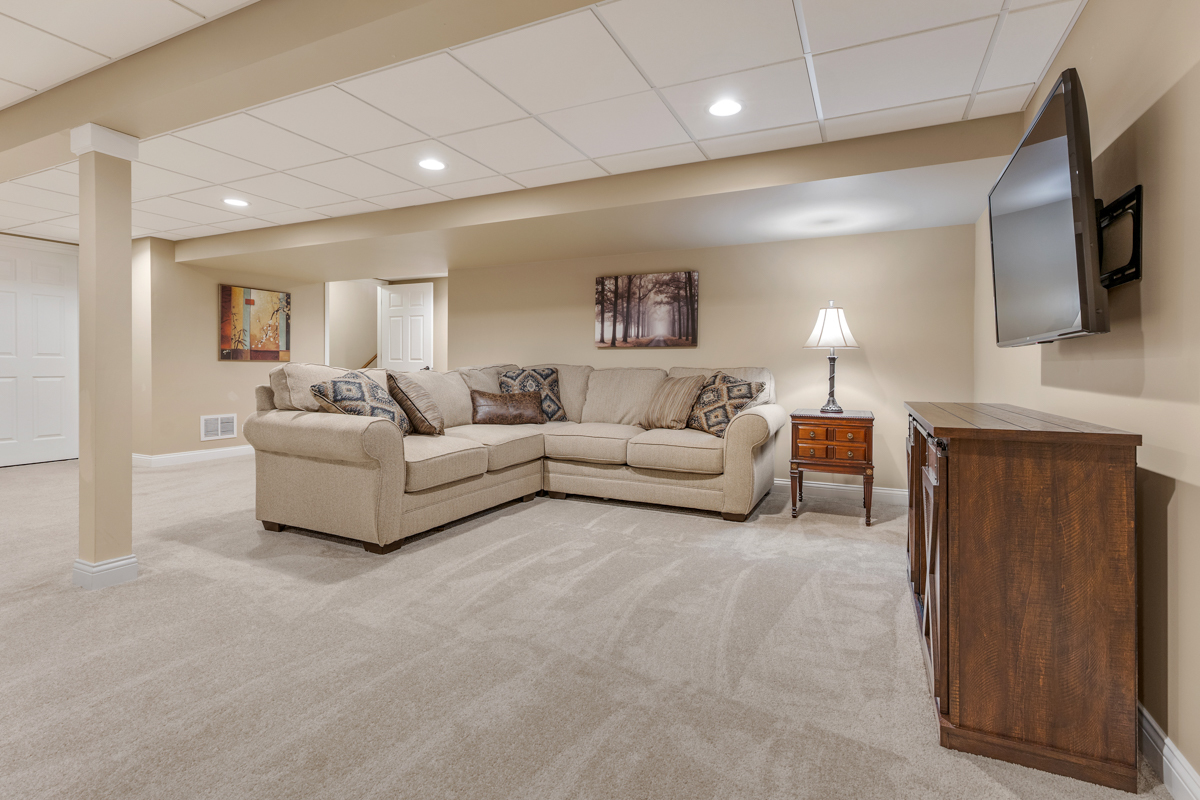 1093 Glendale Road Pingree Grove, IL 60140 - Photo 18 of 28 a living room with furniture a flat screen tv and a fireplace