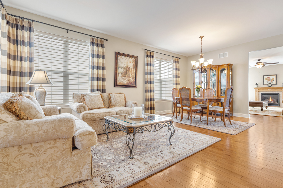 1093 Glendale Road Pingree Grove, IL 60140 - Photo 4 of 28 a living room with furniture and a chandelier