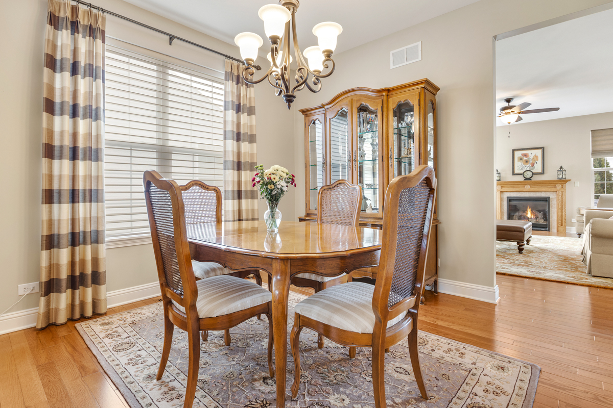1093 Glendale Road Pingree Grove, IL 60140 - Photo 5 of 28 a view of a dining room with furniture and wooden floor