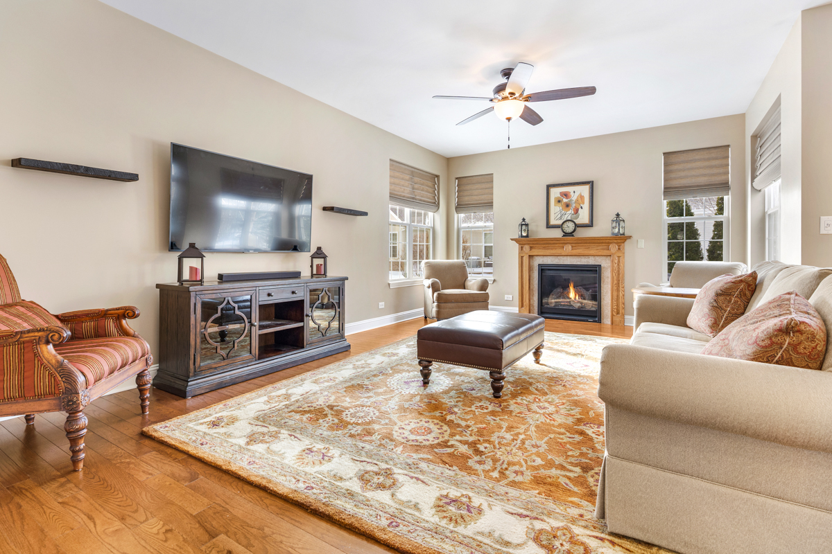 1093 Glendale Road Pingree Grove, IL 60140 - Photo 6 of 28 a living room with furniture a fireplace and a flat screen tv