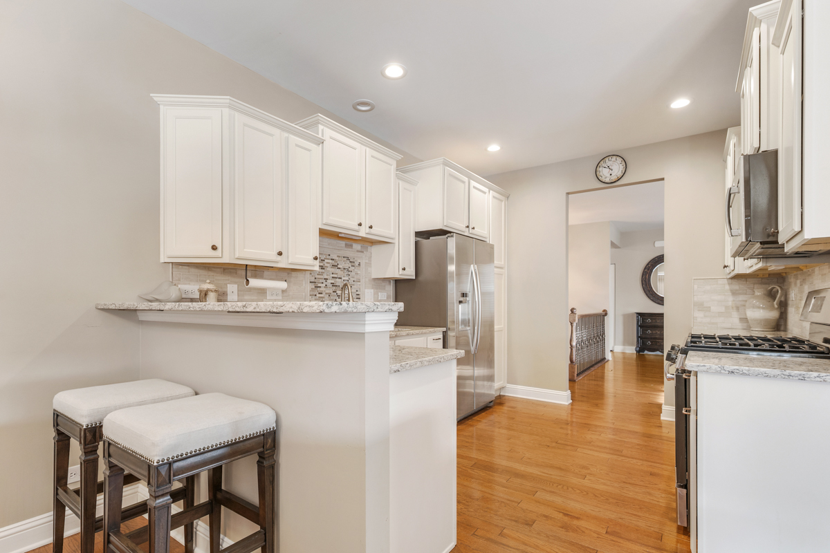 1093 Glendale Road Pingree Grove, IL 60140 - Photo 8 of 28 a kitchen with stainless steel appliances granite countertop a table chairs sink and cabinets
