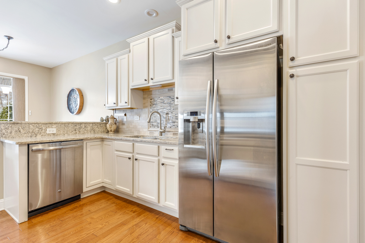 1093 Glendale Road Pingree Grove, IL 60140 - Photo 10 of 28 a kitchen with granite countertop stainless steel appliances a refrigerator a sink and cabinets