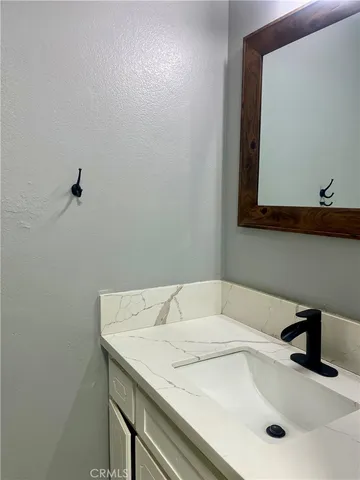 a utility room with granite countertop cabinets washer and dryer