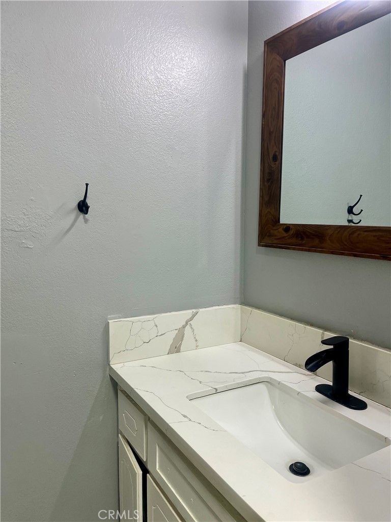 16535 Pine Street, Unit B Hesperia, CA 92345 - Photo 15 of 22 a bathroom with a sink and a vanity