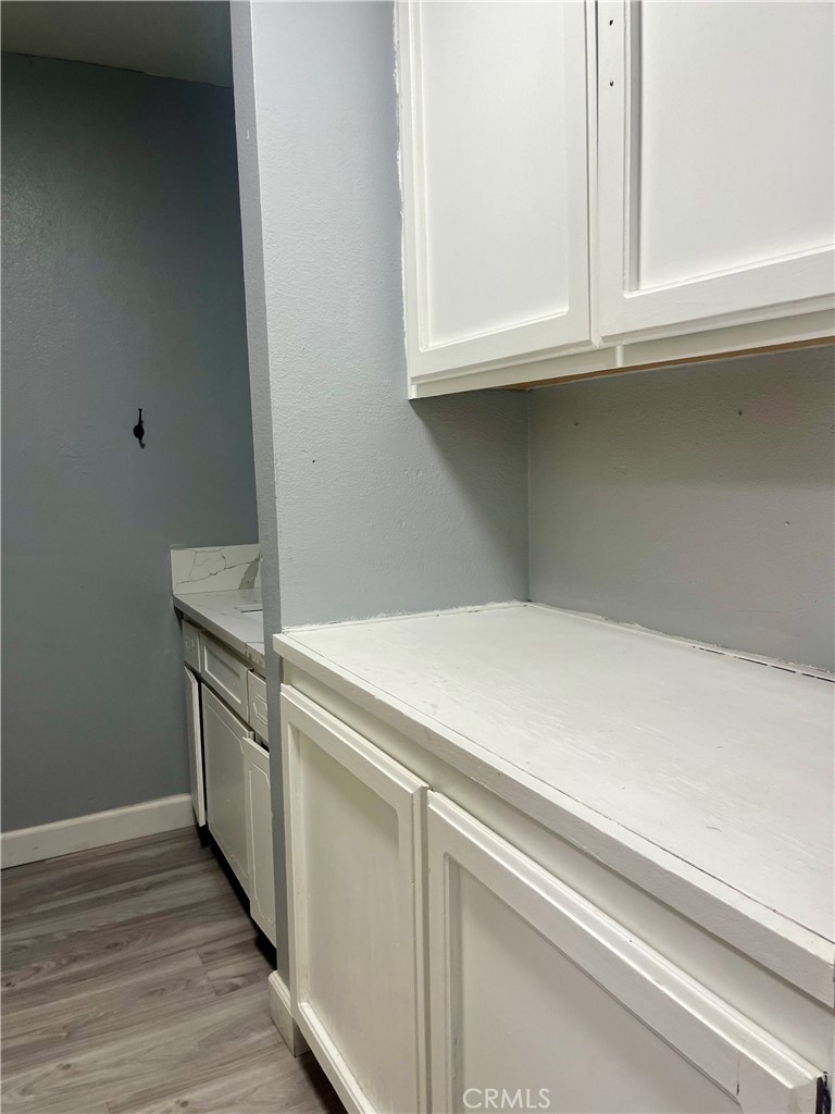 16535 Pine Street, Unit B Hesperia, CA 92345 - Photo 16 of 22 a utility room with granite countertop cabinets washer and dryer