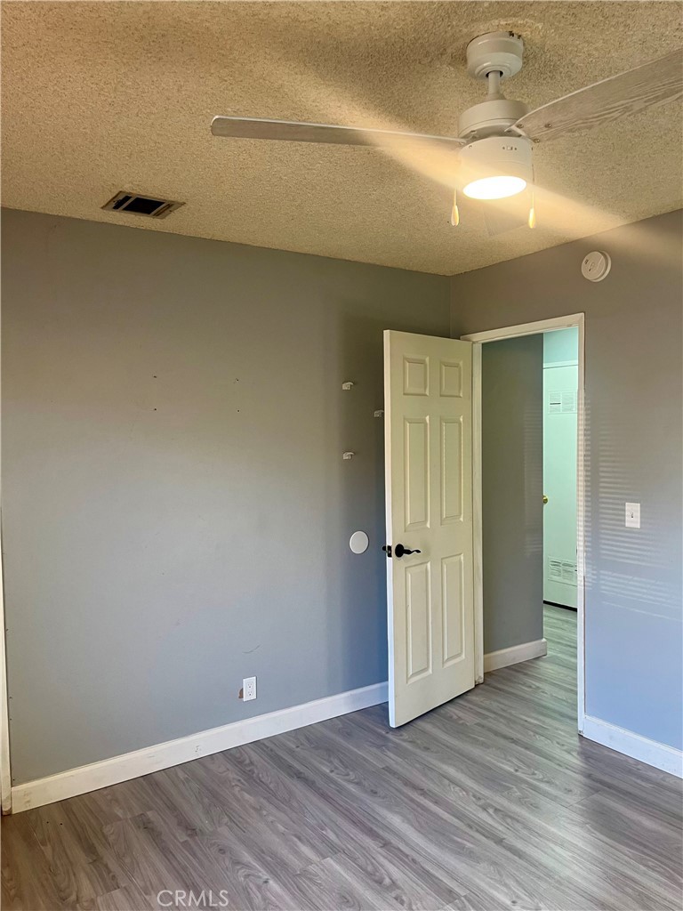 16535 Pine Street, Unit B Hesperia, CA 92345 - Photo 22 of 22 a view of an empty room with wooden floor