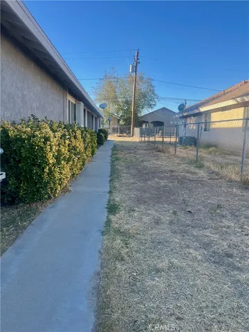a view of a pathway of a house with a yard