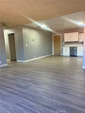 a kitchen with stainless steel appliances wooden cabinets and a wooden floor